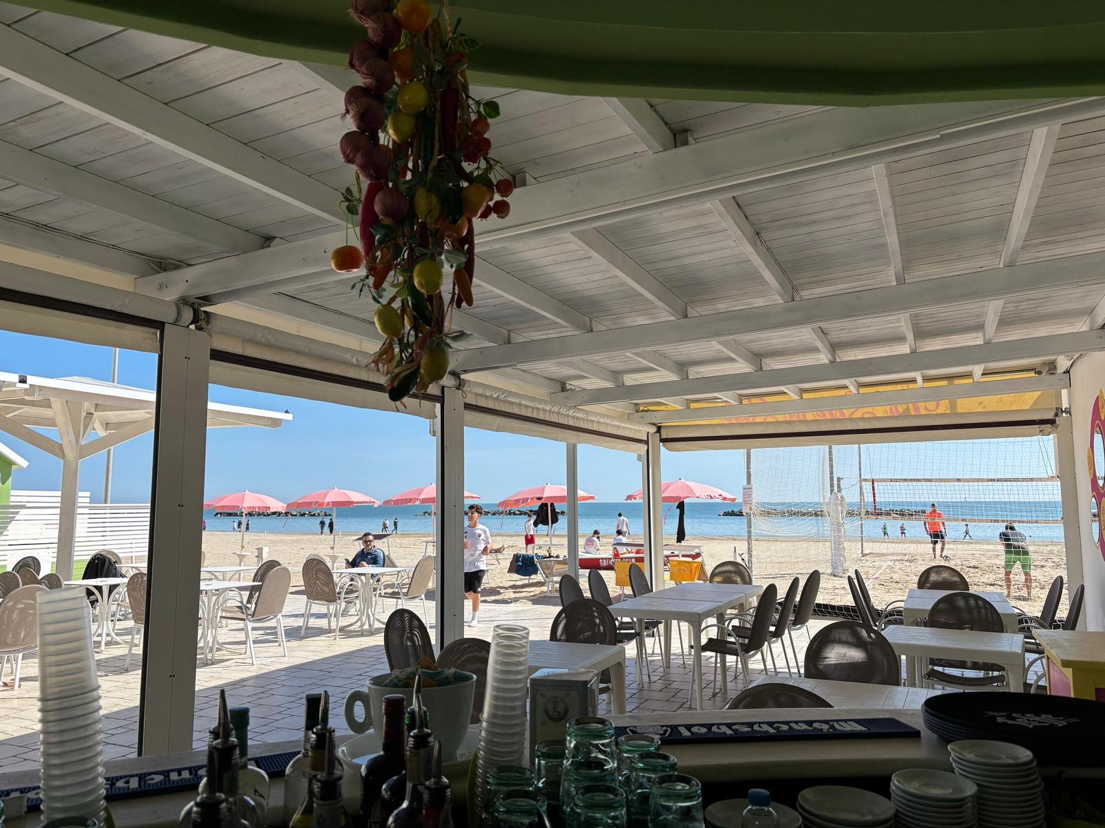 Terrazza dello chalet con vista mare e ombrelloni rosa